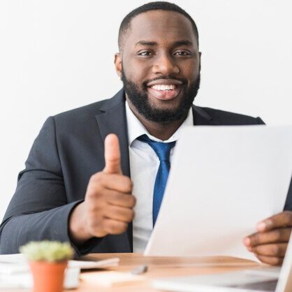 ethnic-businessman-gesturing-thumb-up_23-2147768596